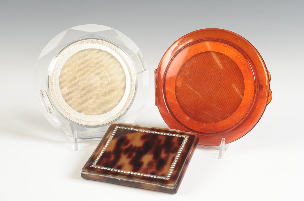 FRENCH CELLULOID & TWO VINTAGE PLASTIC COMPACTS: French celluloid compact in a blonde tortoiseshell pattern, jeweled top, beveled mirror, mesh sifter, marked inside the base, measures 3.5 x 3.75, mirror corners are cracked, lid is slightly warped. P