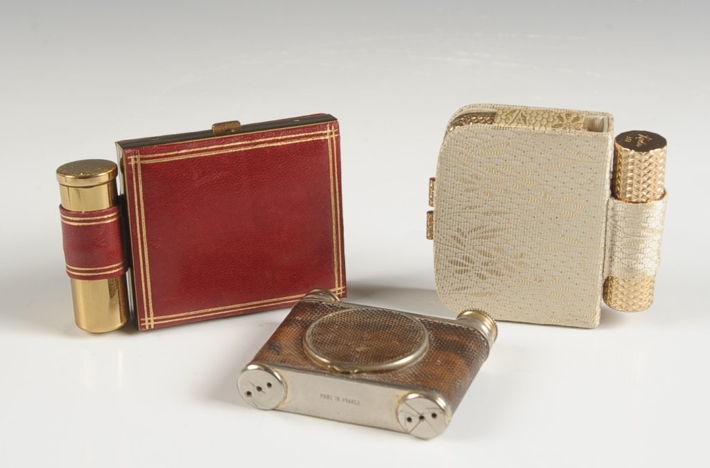 LE KID FRENCH CAMERA-STYLE VANITY CASE & TWO MORE: French Le Kid camera-style vanity case with lizard-skin leather, lipstick and perfume atomizer in each side, compact in the center with mirrored lid and puff, marked on the atomizer, measures 2.25 x 2