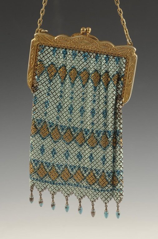 WHITING AND DAVIS 'EL-SAH' ENAMELED ARMOR MESH BAG: Gilded frame with chain handle, enameled drops along the bottom, marked on the inside frame, measures 7 x 3.75 inches with a 5.5 inch drop from the handle.