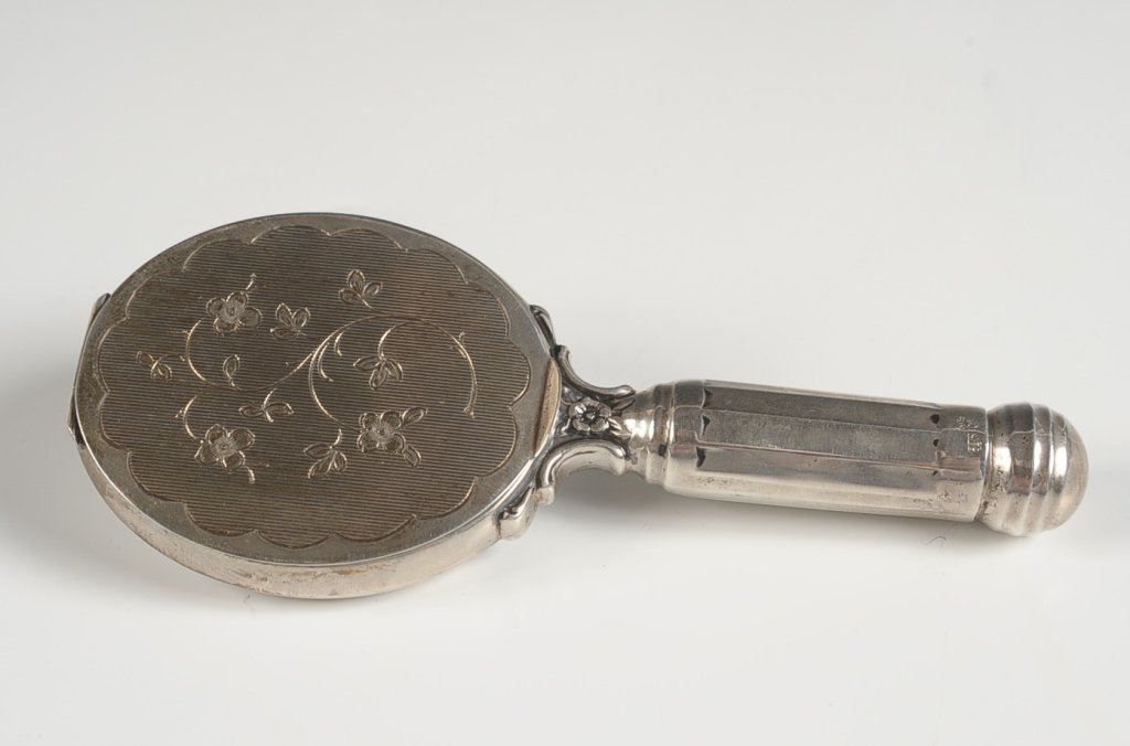 .835 COMPACT HAND MIRROR WITH LIPSTICK HANDLE: Mirrored back and mirror in the compact lid, puff and mesh sifter present, marked on the handle, measures 5.25 x 2.25 inches, weighs 2.2 ozt.