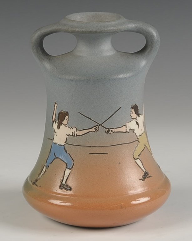 WELLER DICKENS WARE TWO-HANDLED VASE: Marked with the Weller Dickens Ware half round seal, measures 5.75 x 4.5 inches. Please note that this item will be shipped by our in-house shipping department and is subject to a 14 day return policy