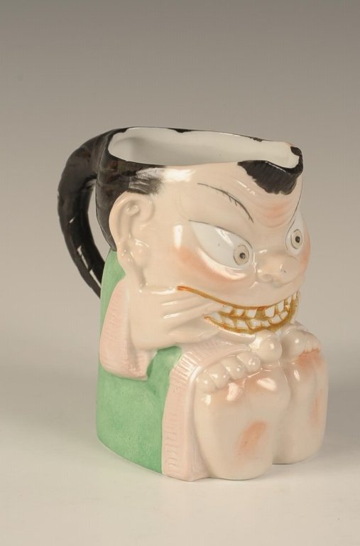 SCHAFER & VATER SMILING CHINESE CREAMER: Color glaze, impressed mark, measures 4 x 4.25 inches. Please note that this item will be shipped by our in-house shipping department and is subject to a 14 day return policy guarantee. If any piece i
