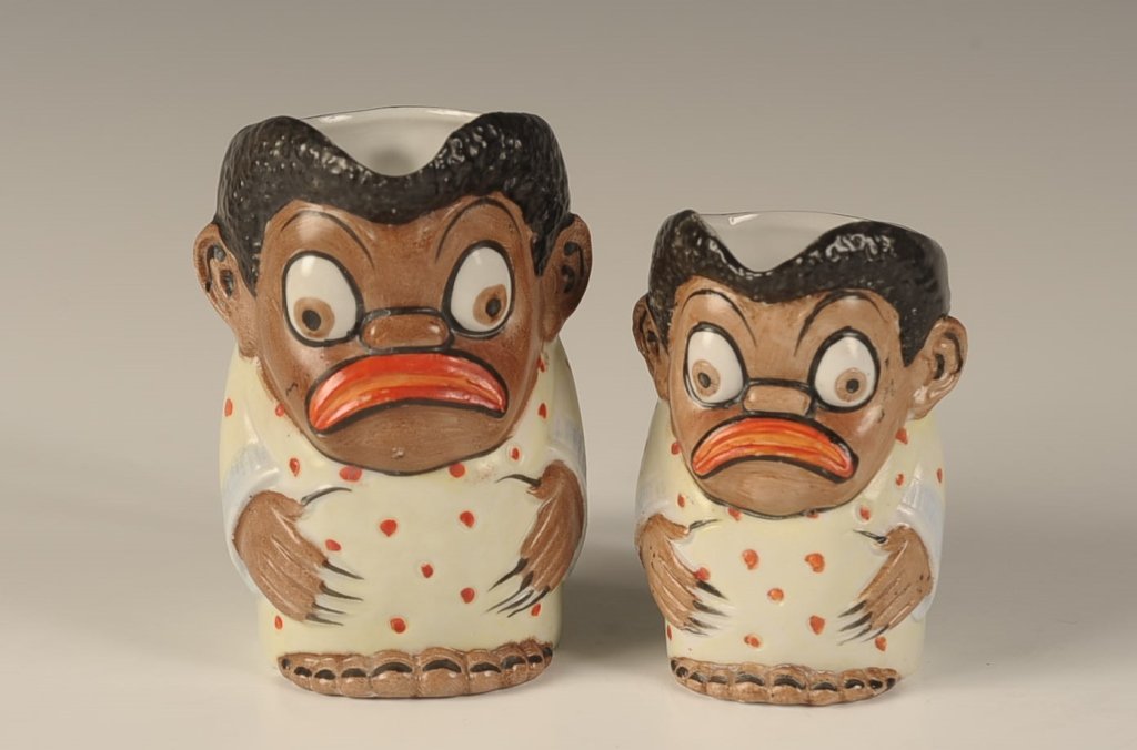 TWO SCHAFER & VATER BLACK AMERICANA CREAMERS: Two sizes, color glazes, impressed marks, measure 3.5 and 4 inches. Please note that this item will be shipped by our in-house shipping department and is subject to a 14 day return policy guarantee. I