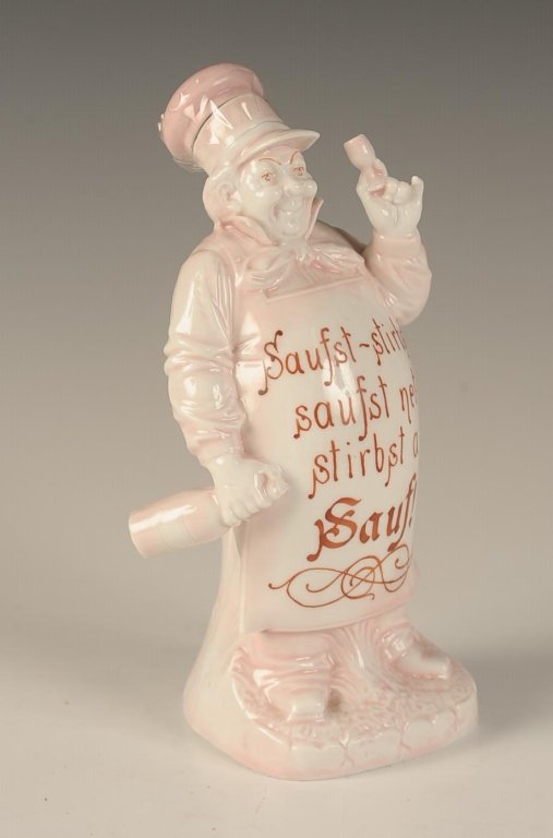 SCHAFER & VATER 'SAUF' BAKER FLASK: With the German phrase 'If you booze, you die. If you don't booze, you also die. So booze!', pink and white glaze, impressed mark, measures 7.5 x 4 x 3.25 inches. Please note that this item will be sh