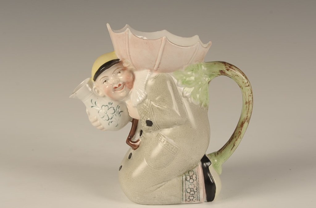 SCHAFER & VATER KNEELING MAN W UMBRELLA COLOR PITCHER: Faint impressed mark, measures 5 x 5.5 x 3 inches. Please note that this item will be shipped by our in-house shipping department and is subject to a 14 day return policy guarantee.