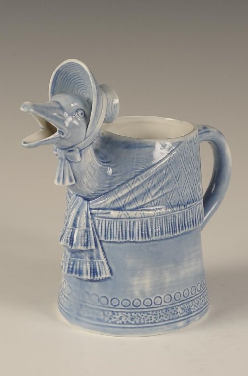 SCHAFER & VATER MOTHER GOOSE BLUE GLAZE CREAMER: Impressed mark, measures 6.25 x 6.75 x 3.5 inches. Please note that this item will be shipped by our in-house shipping department and is subject to a 14 day return policy guarantee. If any piece in th