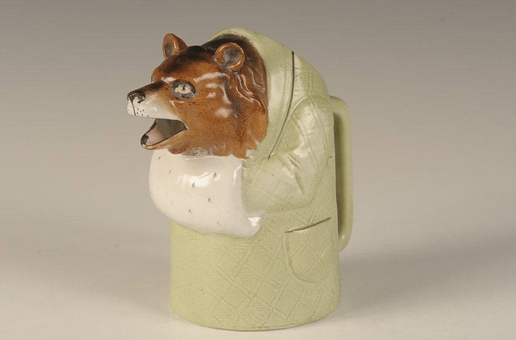 SCHAFER & VATER DRESSED BEAR CREAMER: Color glaze, faint impressed mar, measures 5 x 5.5 x 3.5 inches. Please note that this item will be shipped by our in-house shipping department and is subject to a 14 day return policy guarantee. If a