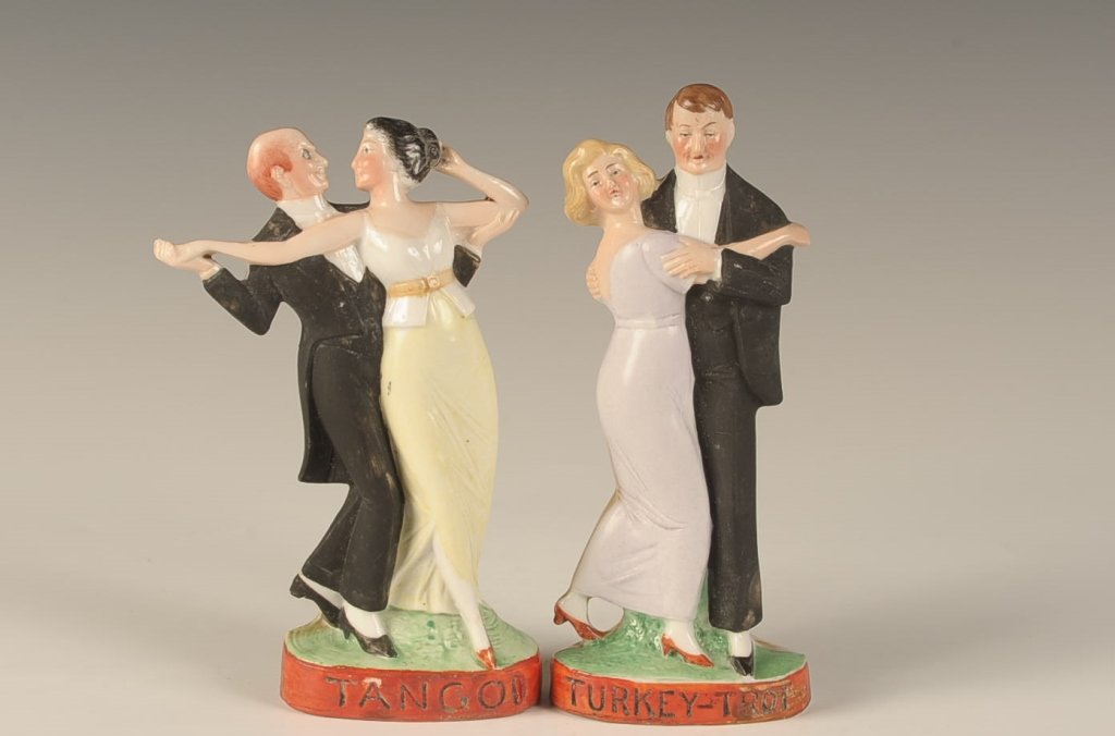 TWO SCHAFER & VATER DANCING COUPLE FLASKS: Turkey Trot' and 'Tango', no impressed marks, measure 6 inches each. Please note that this item will be shipped by our in-house shipping department and is subject to a 14 day return policy guarantee.