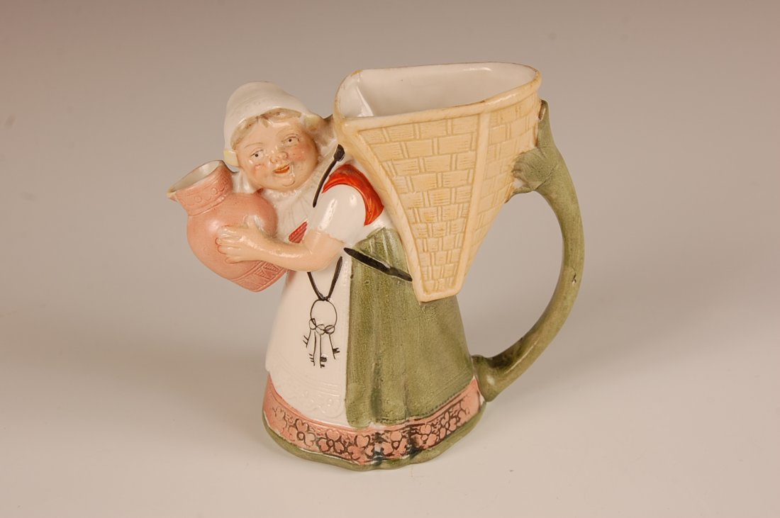 SCHAFER & VATER GIRL WITH PITCHER & BASKET CREAMER: Color glaze, impressed mark, measures 4 x 4.75 x 2.75 inches. Please note that this item will be shipped by our in-house shipping department and is subject to a 14 day return policy guarantee.