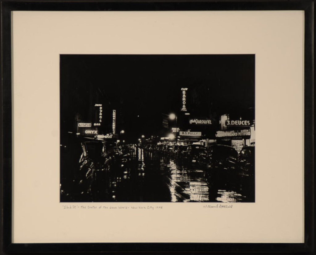 WILLIAM P. GOTTLIEB (1917-2006) SIGNED PHOTOGRAPH: A gelatin silver print photograph titled '52nd St. - Center of the Jazz World,' dated New York City 1948 and signed lower right on the image and on the mat. Image measures 10 x 13 inches with an overa
