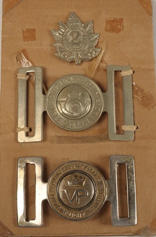 LARGE LOT OF CANADIAN MILITARY BADGES, BUCKLES,: Includes Princess Patricia's Canadian Light Infantry and Queen's Own Rifles of Canada belt buckles, plus a Queen's Own Rifles cap badge and sleeve arc; Manitoba Tag Day 1910 celluloid button; badges f
