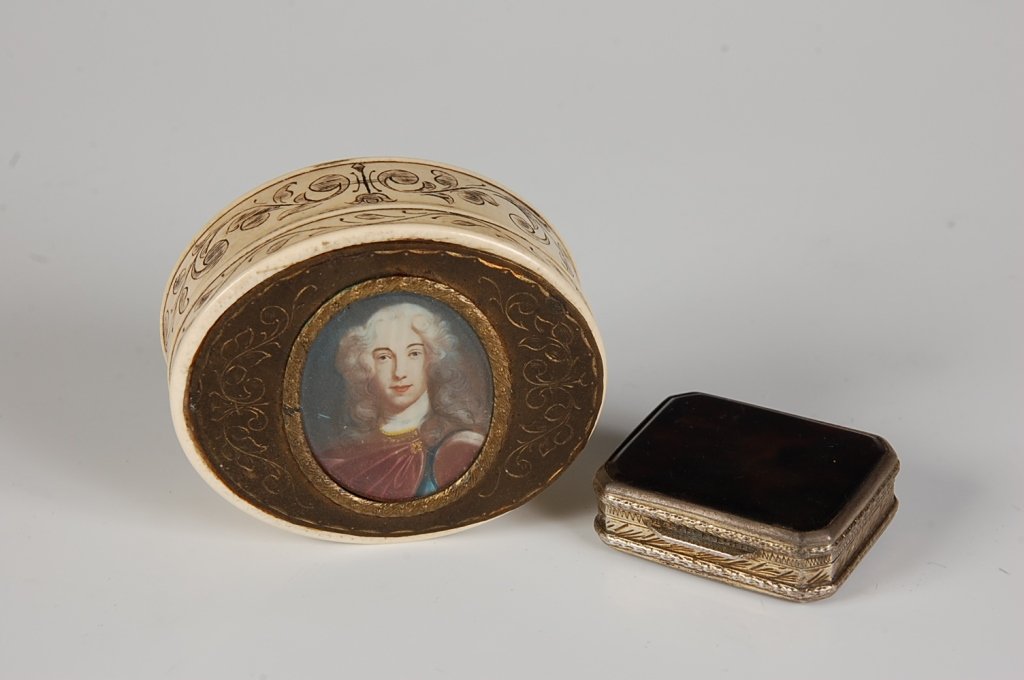 TWO 19TH CENTURY IVORY AND TORTOISE BOXES: An oval ivory box with scrimmed designs and a central hand painted portrait. Plus a small .800 silver box with tortoise-like materials. Portrait box measures 2.5 x 2 inches. Tortoise shell box measure