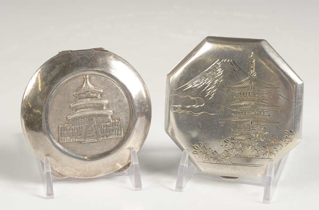 STERLING COMPACTS WITH ASIAN DESIGNS: Sterling compact with a chased scene of Mount Fuji and a pagoda on top, signed on the bottom, framed mirror in the lid, hinged powder well, marked in the powder well, measures 3 inches, weighs 2.8 ozt