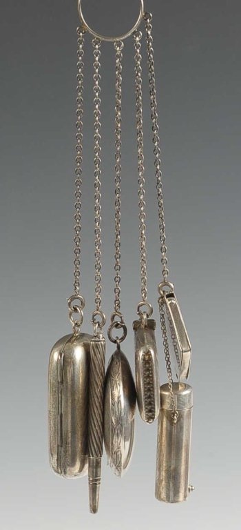 STERLING CHATELAINE WITH FINGER RING: Five chains with dangles of a compact with mirrored lid, change holder, match holder, mechanical pencil, stamp holder over a lipstick, monograms of some pieces, marked sterling throughout, measures 7.
