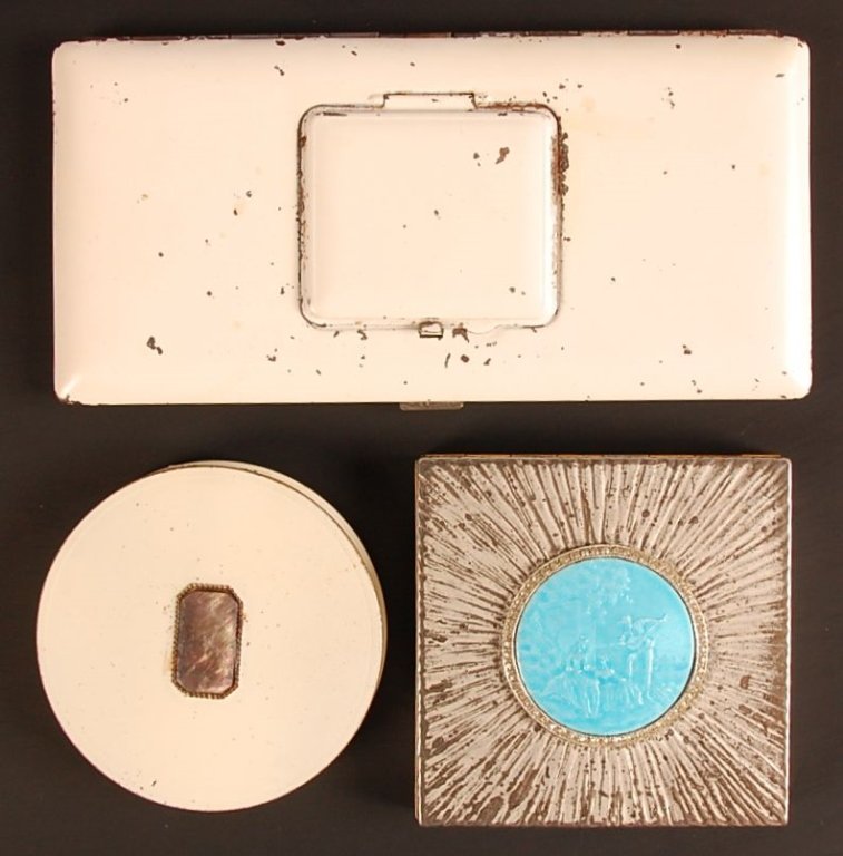 EVANS COMPACT W GUILLOCHE, ENAMELED COMPACT &: Evans silvertone compact with an embossed guilloche decoration on top, mirrored lid, mesh sifter and branded puff, marked in the powder well, measures 3.25 inches. Plus a white enamel Rex Fifth Avenue