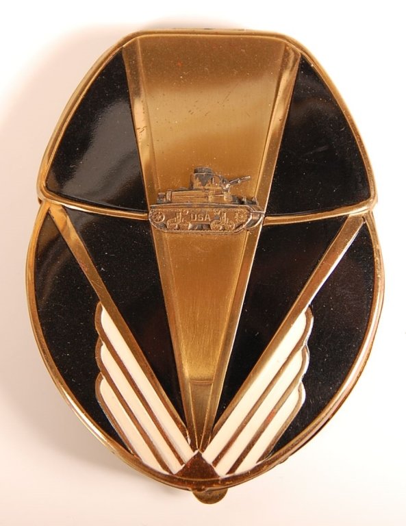 ENAMELED DUO COMPACT WITH A U.S. TANK MOTIF: Black and white enamel on a goldtone duo compact with a military tank decoration on the top, framed mirror in the lid, base holds hinged wells for cream rouge and powder with a shaped puff, unmarked,