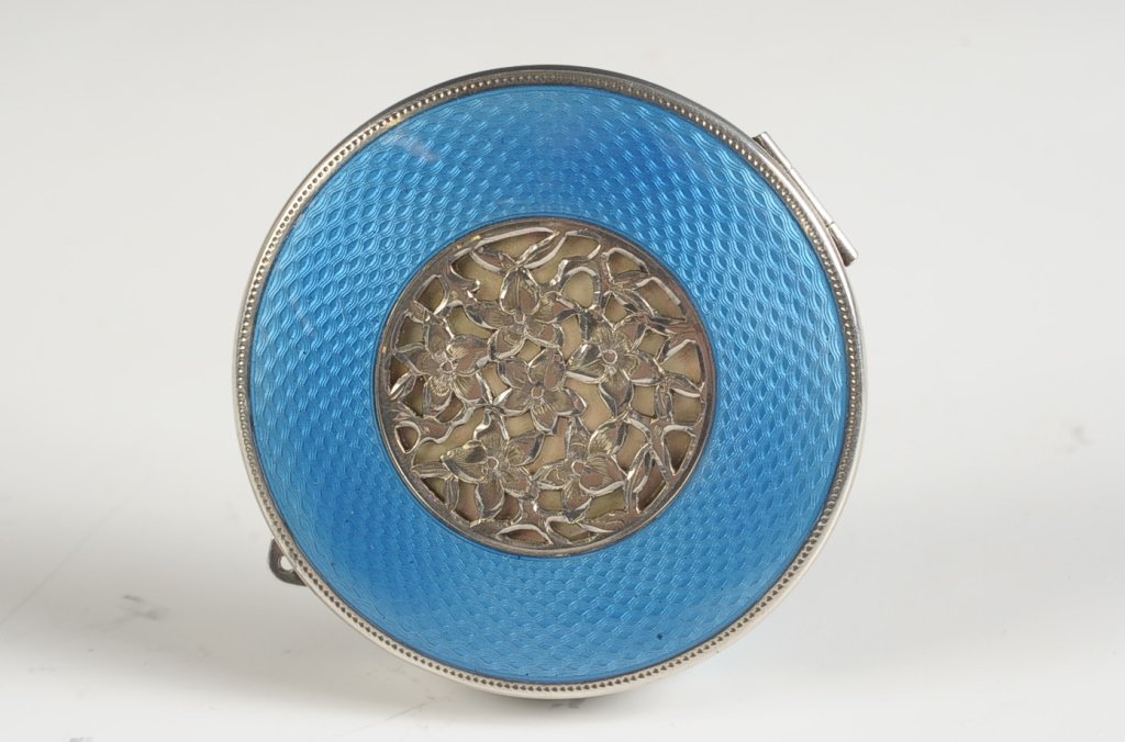 ELGIN AMERICAN STERLING GUILLOCHE COMPACT W FILIGREE: Blue guilloche enamel on sterling surrounds a filigree floral in the center top, framed mirror in the lid, metal insert in the base holds a lipstick, two rouge wells with a swinging lid, powder well w