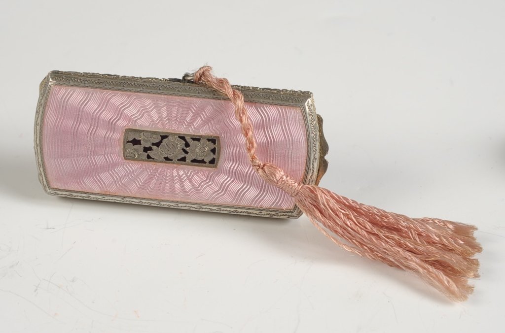 AUSTRIAN STERLING GUILLOCHE & FILIGREE COMPACT: Pink guilloche top with a filigree floral decoration in the center over purple satin, lipstick with a cord tassel inserts in one side, framed beveled mirror in the lid, gilded base holds rouge and pow