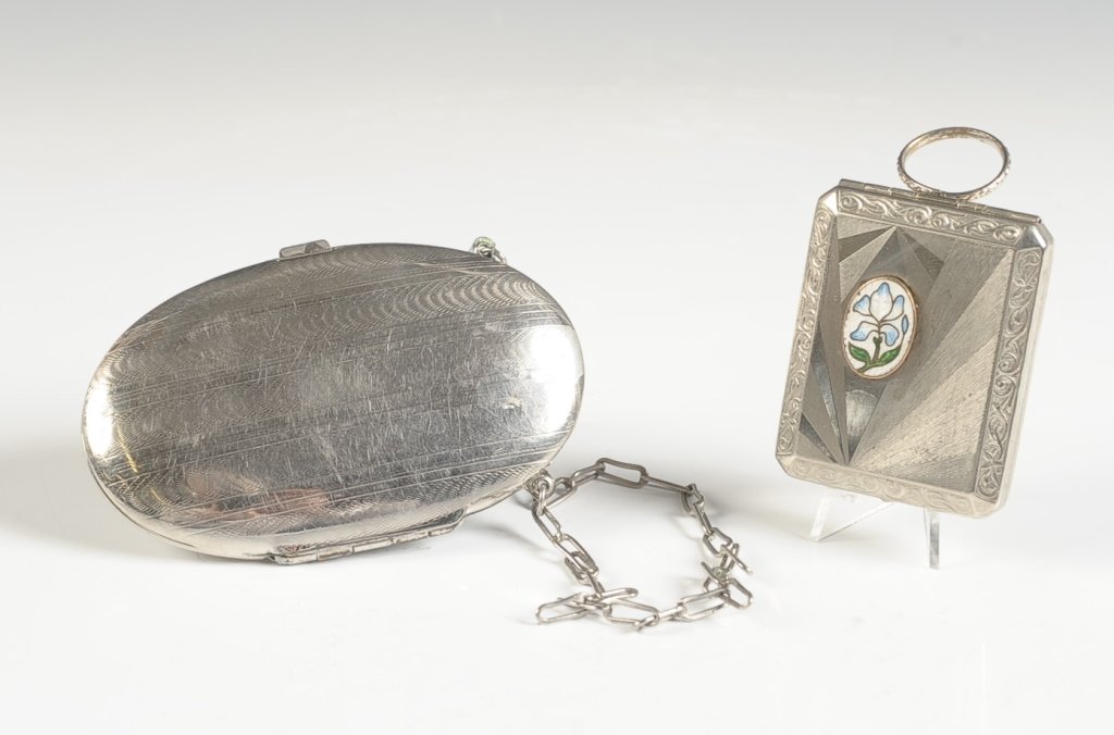 EBM CO. COMPACT W GUILLOCHE, MINIAUDIÈRE: Silvertone duo compact with a finger ring and guilloche floral decoration, framed mirror in the lid, base holds a hinged rouge well with a pan and a powder well with rotary sifter, marked on the mirro
