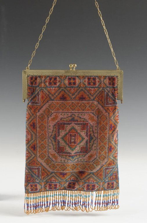 ANTIQUE BEAD KNITTED BAG: Persian rug design with beaded fringe, goldtone frame and chain handle, satin lining with pocket and hand mirror, unmarked, measures 10 x 6.25 inches, with a 6 inch drop from handle.