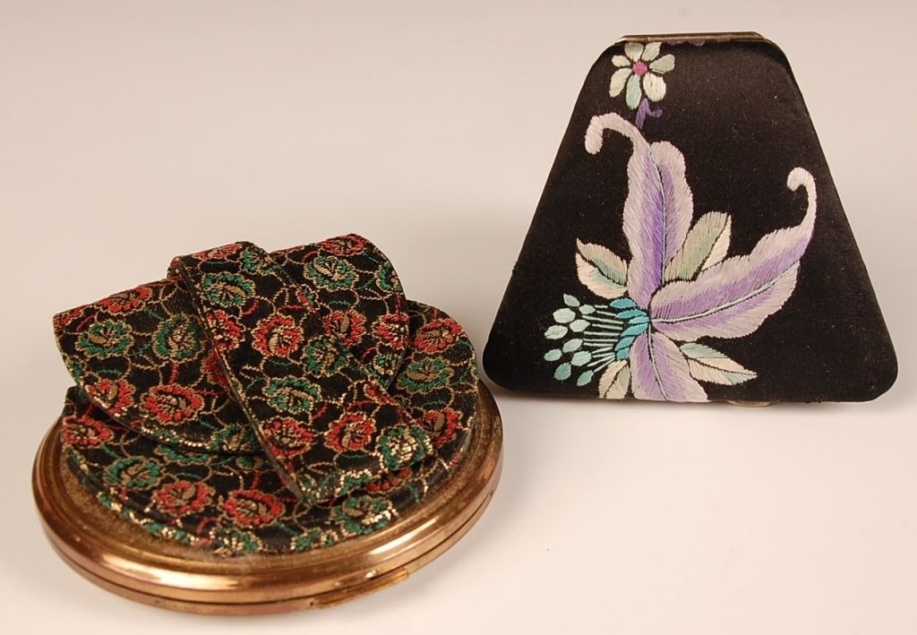 BROCADE AND EMBROIDERED SATIN COVERED COMPACTS: Two pieces, with one smaller piece that measures 3.25 x 3.75 inches, and the larger piece measures 8.5 x 4 inches.