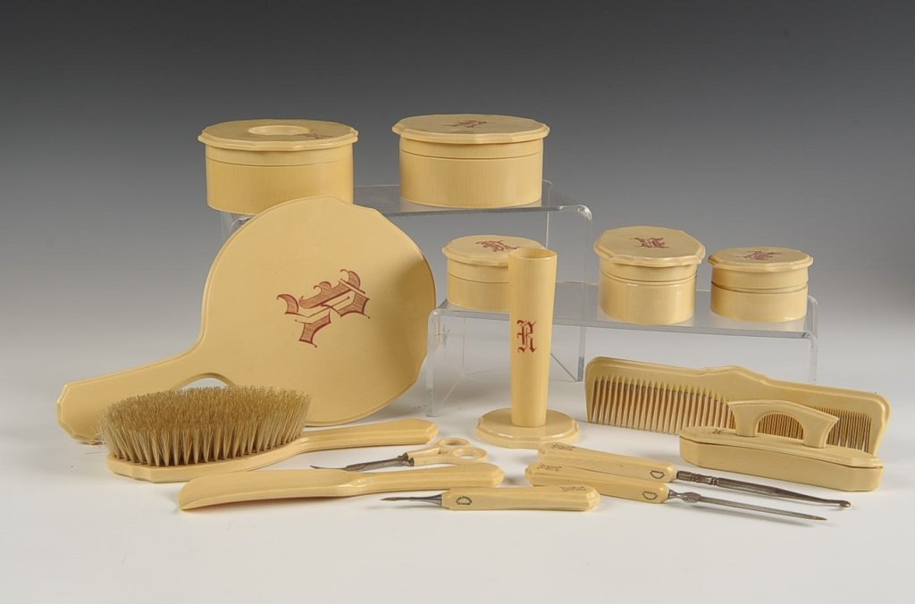 15 PC. DU BARRY CELLULOID DRESSER SET: Monogrammed with an 'R', includes a hand mirror, hair brush, bud vase, hair receiver, four lidded boxes, three piece manicure set, comb, button hook, nail buffer and a shoe horn, marked 'Ivory Pyralin