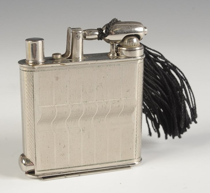 D.G.R.M. FAUX LIGHTER VANITY CASE WITH PERFUME: German silvertone vanity case disguised as a lighter, hinged 'striker' lifts up to release a perfume vial with screw top and dauber, kohl inserts in the top, lipstick slides out from the base, polishe
