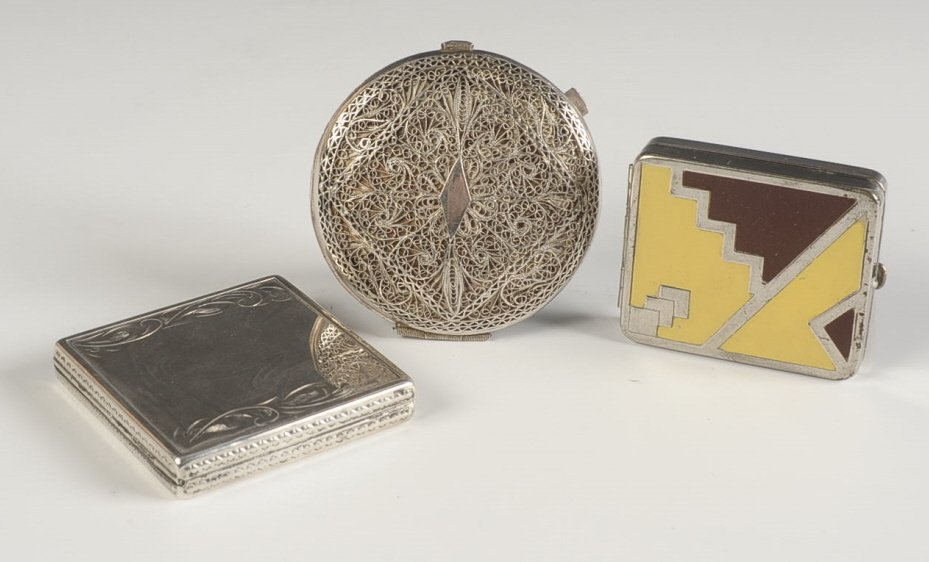 CHARME STERLING COMPACT, ENAMELED & FILIGREE COMPACTS: Sterling compact with mirrored lid, branded puff and sifter, measures 2.25 inches, weighs 2.2 ozt., very good. An elaborate silvertone filigree comapct with mirrored lid and mesh sifter in the base, u