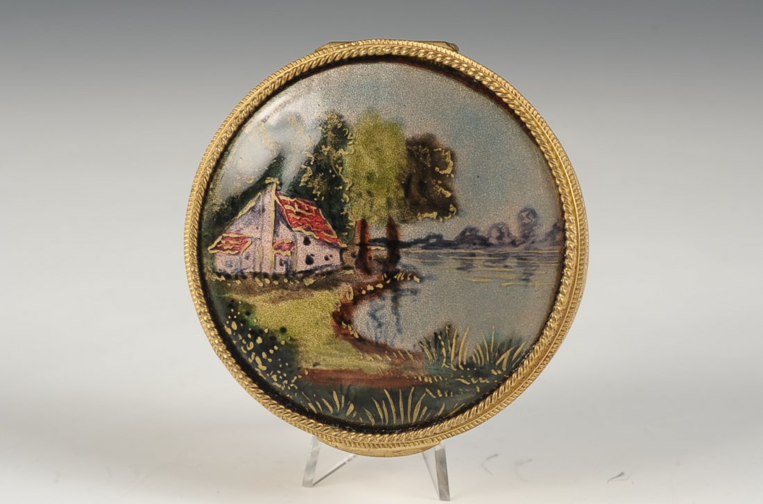 COMPACT WITH HAND PAINTED ENAMEL LANDSCAPE: Goldtone compact with a hand painted landscape on top, framed beveled mirror in the lid, puff is present, unmarked, measures 3 inches.