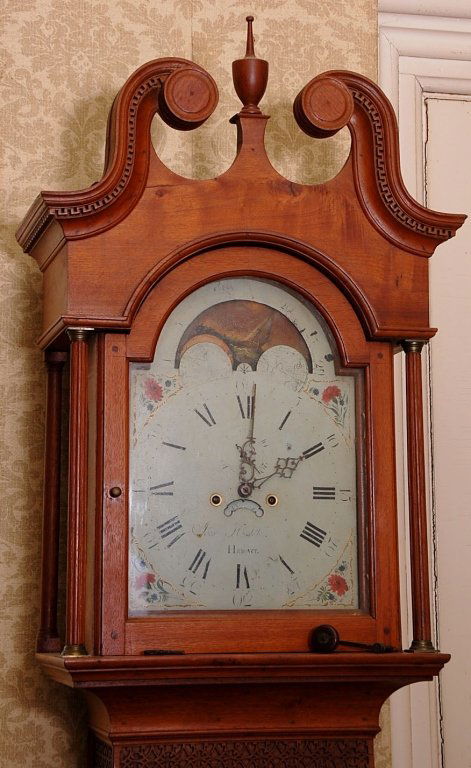 JACOB HOSTETTER, PENNSYLVANIA CHIPPENDALE TALL CLOCK: Late 18th century Chippendale tall clock, walnut case with broken arch crested bonnet, arched door, four Corinthian columns, all original painted iron moon phase dial with floral decorated spandrels,