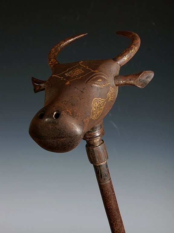 C. 1800 PERSIAN BULL HEAD MACE WITH GOLD DECORATION: A rare ceremonial mace made of iron with silver and gold damascene decoration. Measures 28 x 7.5 inches.
