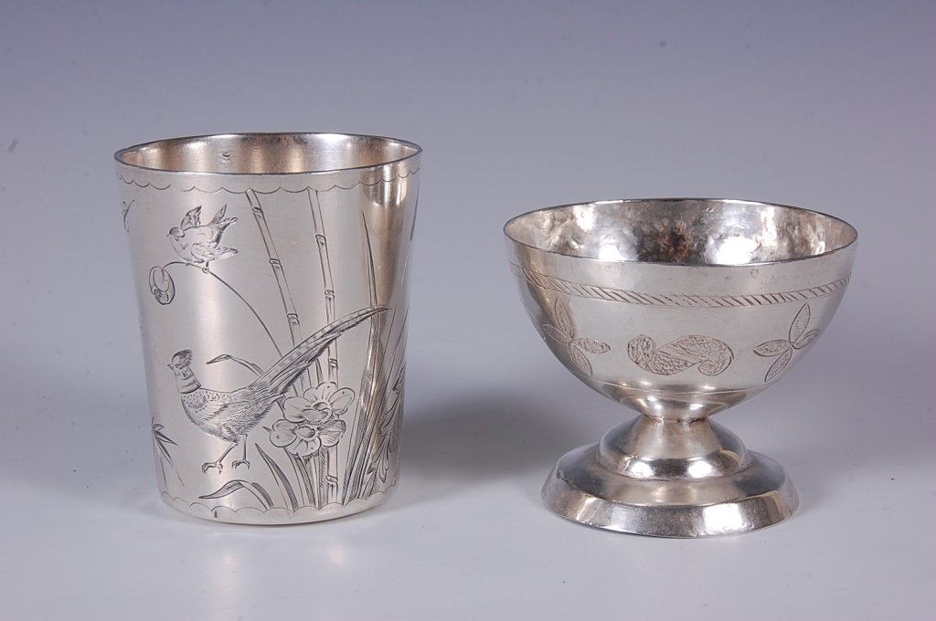 A FRENCH SILVER BEAKER: A French engraved silver beaker with hallmark near the rim, plus another engraved piece on which no markings were found. Two pieces with the French measuring 3 x 2.75 inches and the other measures 2.5