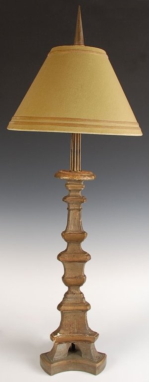 ANTIQUE ALTAR STICK TABLE LAMP: A carved tricorn base of later vintage supports a carved and gessoed altar stick circa 18th century with an added table lamp assembly above. Measures approximately 35 x 7 inches at the base of the lam