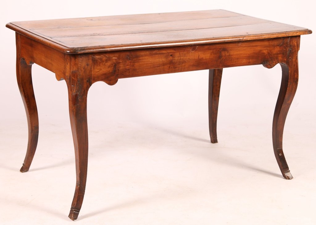 CIRCA 1800 FRENCH PROVINCIAL FRUITWOOD HARVEST TABLE: The three-board rectangular top with batten ends above a single drawer case with an incised and scalloped apron and rising on cabriole legs terminating in hoof feet. Measures 29 x 47.5 x 30 inches.