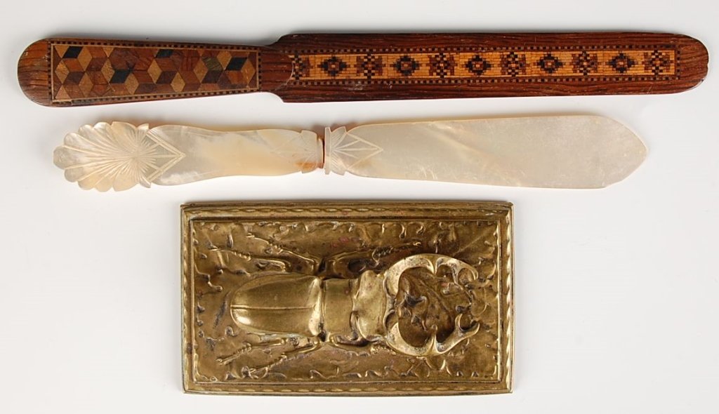 GROUP OF ANTIQUE DESK ITEMS INCLUDING BEETLE BILL CLIP: A Tunbridge ware letter opener, a mother-of-pearl letter opener, and a Victorian beetle figural clip. Three pieces ranging in size from 4.5 x 2.5 inches, up to 9.5 inches in length.