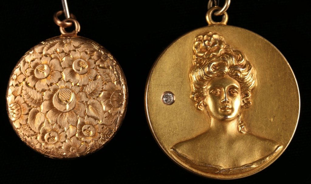 TWO LATE VICTORIAN LOCKETS INCLUDING 14K: The smaller engraved example marked 14k, the larger example with Gibson girl and brilliant is unmarked. The larger in size measures 1.5 inches in diameter, and the other measures 1.25 inches in diamet