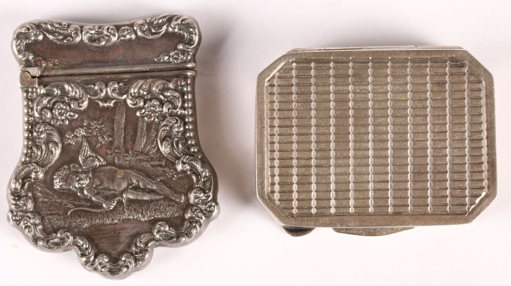 TWO ANTIQUE SILVER BOXES: Including a flat stamp box with cherub marked Sterling, and a Continental box marked .800. The one small box measures 1.25 x 1.5 inches, and the other piece measures 1.75 x 1.5 inches, also marked ste