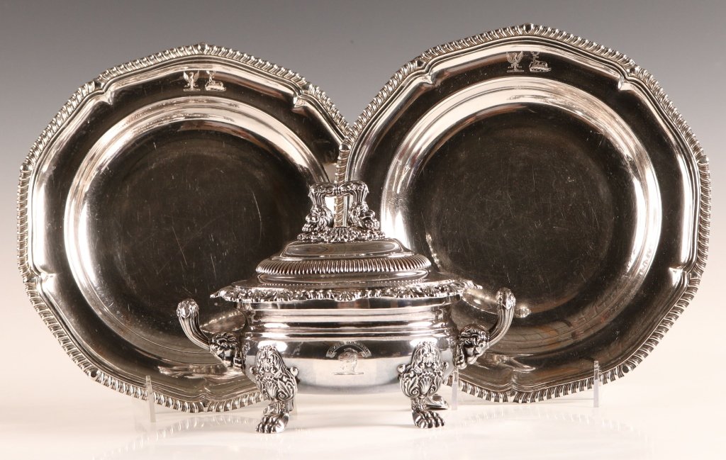 OLD SHEFFIELD PLATE SAUCE TUREEN PLUS TWO PLATES: A footed sauce tureen with shell border and lions head handles, four paw feet and engraved crest. Plus two plates with gadrooned edge and engraved crest. Three pieces, with the tureen that measures 7 