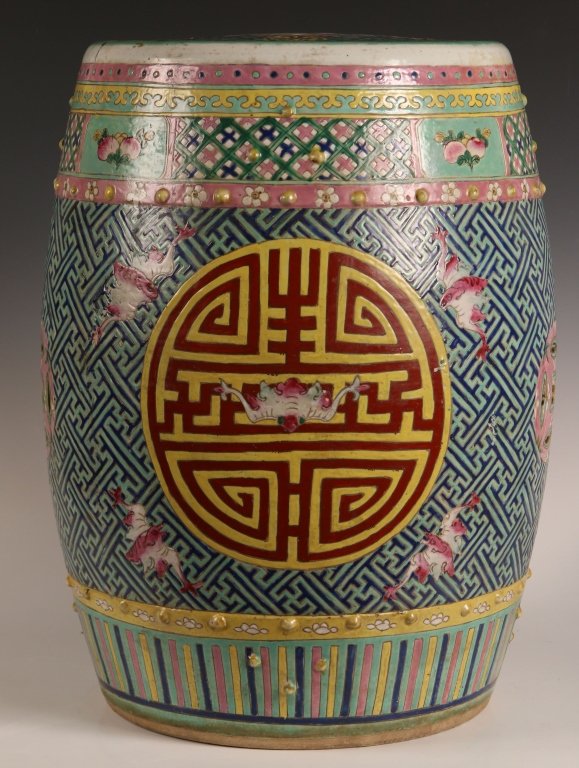 19TH / 20TH C. CHINESE GARDEN STOOL: Chinese, porcelain barrel-form garden stool with auspicious emblems including bats, pierced double-coins, and a central medallion featuring the character "shou," for longevity, in overglaze enamels su