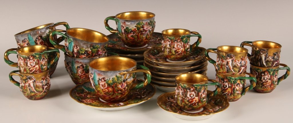 C. 1900 CAPO DI MONTE DEMITASSE & COFFEE SETS: Demitasse size cup and saucer sets and coffee size cup and saucer sets with completely gilded gold interiors, embossed classical figures, blue underglaze mark. Demitasse cups measures 2 x 3 inches wit