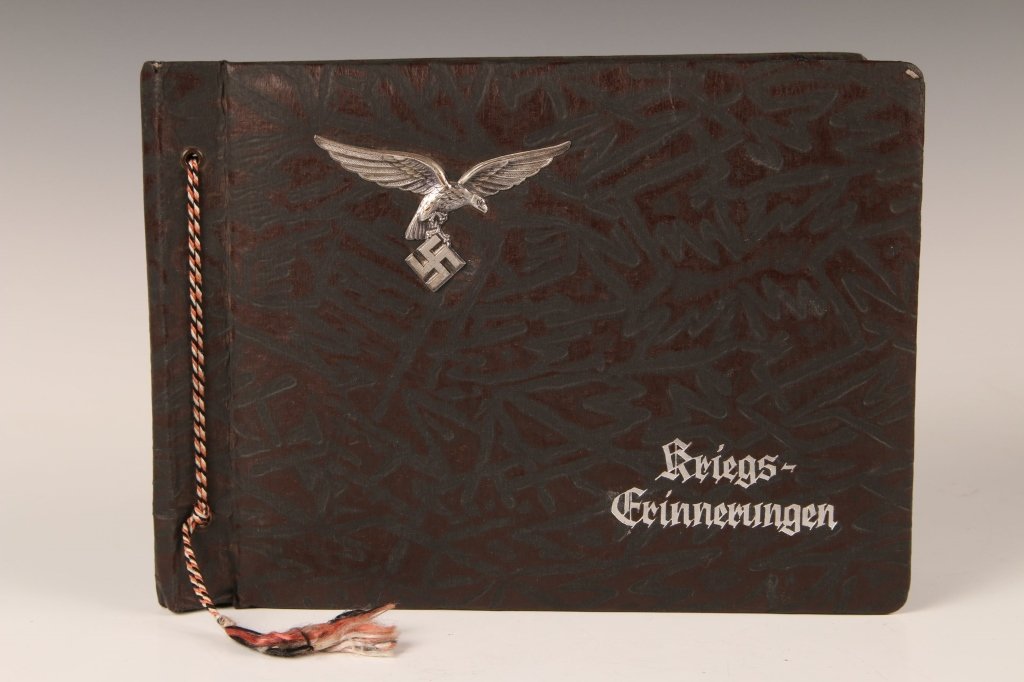 WWII LUFTWAFFE PHOTOGRAPH ALBUM, OCCUPIED FRANCE: 129 photographs in a classic Kriegs-erinnerungen' printed album with applied LW eagle on the cover. Great shots of occupied France, battle damage, men, uniforms, sea planes, night flak, around Paris, 
