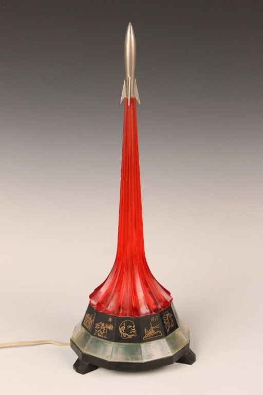 SOVIET ROCKET FORM PATRIOTIC TABLE LAMP: Nice patriotic table lamp celebrating 12 events in Soviet history in a faceted ring around the base; from Lenin, to the revolution, collectivisation, industrialization, space exploration, Great Patrio