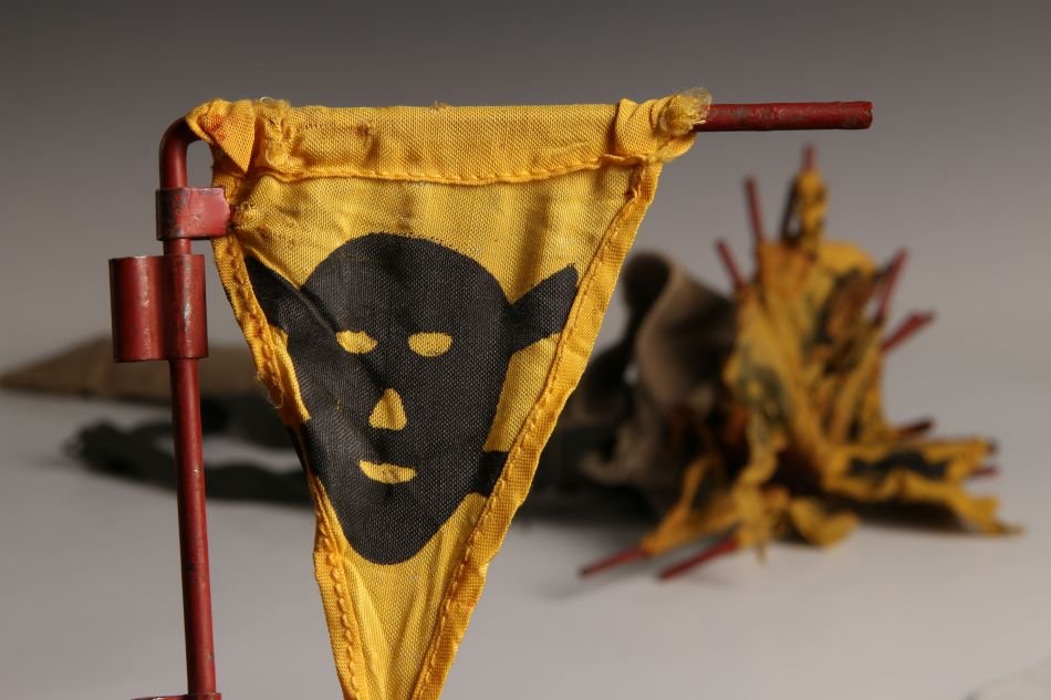 WWII GERMAN MINE FLAGS, SET OF 17: Lot of 17 with red metal dowel rods, printed black skull and crossbones on yellow flags, with tan canvas carrier bag. Measures approximately 24 inches. Unmarked.