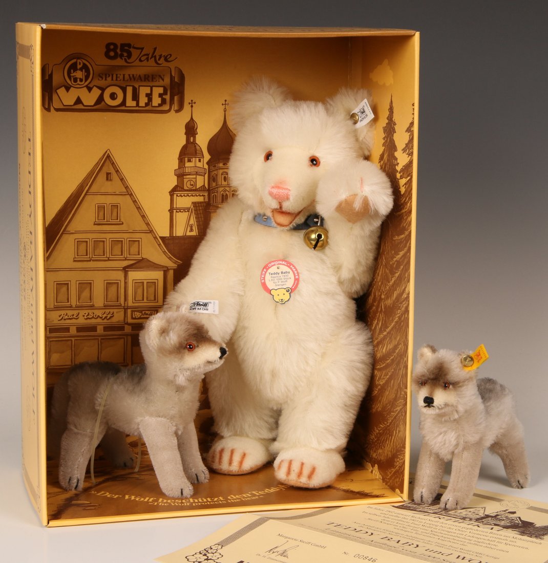 STEIFF TEDDY BABY AND WOLF LIMITED EDITION SET: White teddy baby bear with wolf, 0177/00, limited edition of 1000, buttons in ears and white labels, with original box. Plus another wolf 0127/13 with button in ear and yellow label.