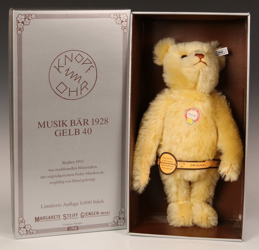 STEIFF REPLICA MUSIK BÄR WITH BOX: Yellow mohair, 1992 replica of a 1928 edition, limited edition of 8000, button in ear with white label, paper chest tag and paper instruction belt, music box plays when the sides are squeezed, with or