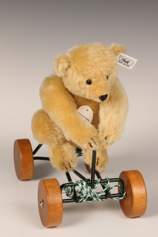 STEIFF MUSEUM COLLECTION RECORD TEDDY WITH BOX: Limited edition 1990 replica of 1927 bear on a pull toy, 400698, button in ear with white label, paper chest tag, with original box.