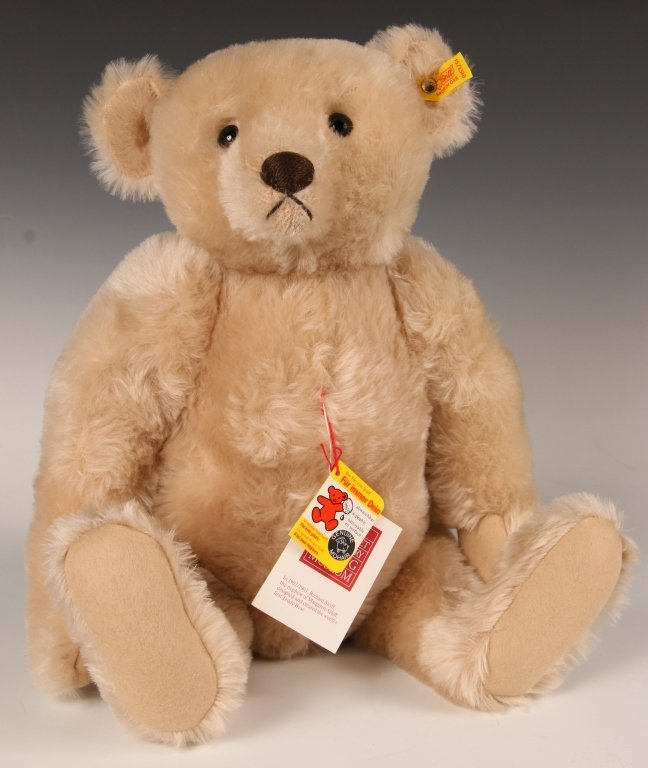 STEIFF 1908 REPLICA MARGARET STRONG CREAM BEAR: 1985 replica of the Margaret Strong 1908 edition, cream mohair, 0157/51, button in ear with yellow label, paper hang tags, measures 20 inches (51 cm).