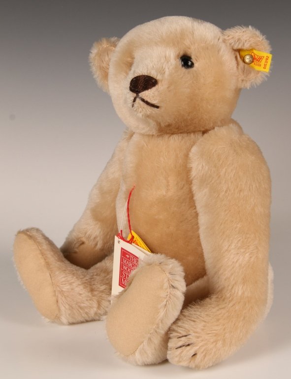 STEIFF 1908 REPLICA MARGARET STRONG CREAM BEAR: 1984 replica of the Margaret Strong 1908 edition, cream mohair, 0157/42, button in ear with yellow label, paper hang tags, measures 16 inches (42 cm).