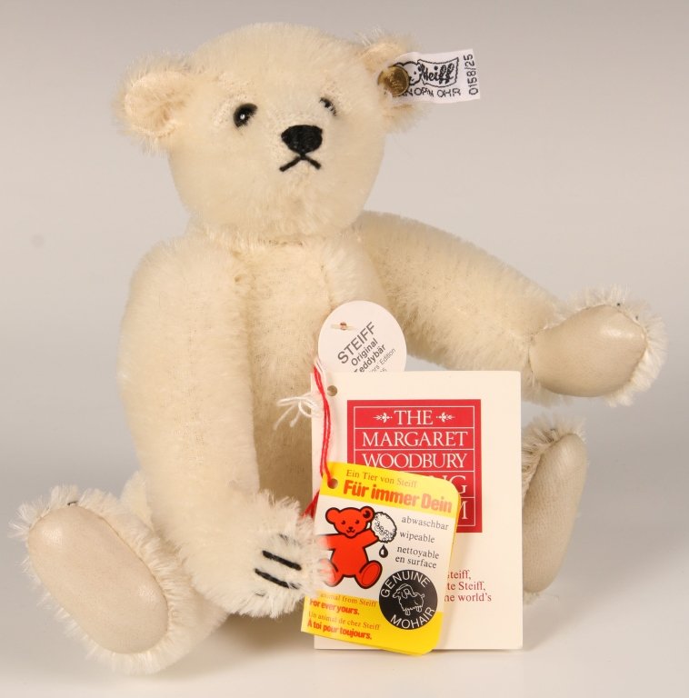 STEIFF MARGARET STRONG WHITE BEAR W LEATHER PAWS: 1985, limited edition of 3000, 0158/25, white mohair with leather paw pads, button in ear with white label, paper chest and hang tags, measures 10 inches (25 cm).
