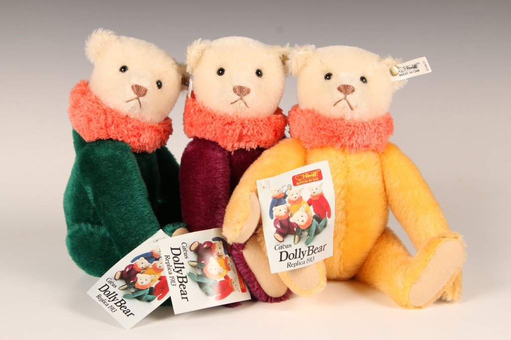THREE STEIFF REPLICA CIRCUS DOLLY BEARS, LIMITED: 1987 replicas of the 1913 editions, in yellow, green and purple colors, buttons in ears with white labels, 0164/31, 32 and 34, paper hang tags, measure 12 inches (30 cm).